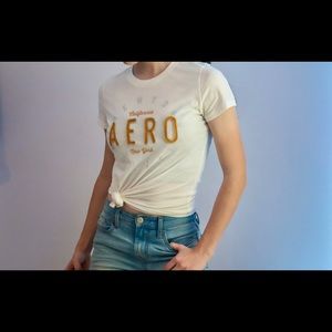 This is a Aeropostale Girls Short Sleeve Tee. White with gold lettering.